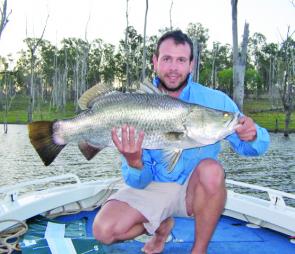 After casting in the shallows and avoiding any losses in the timber, Lyndon displays his decent Monduran barra.